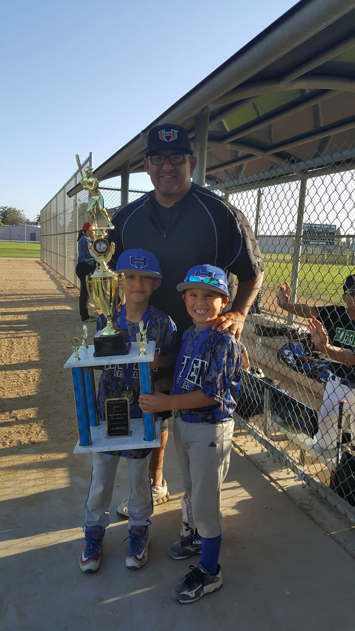 Coach and young champions with trophy
